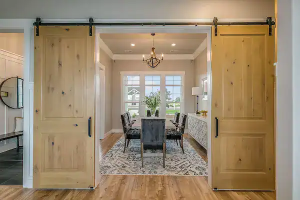 Elegant dining room with sliding barn doors.