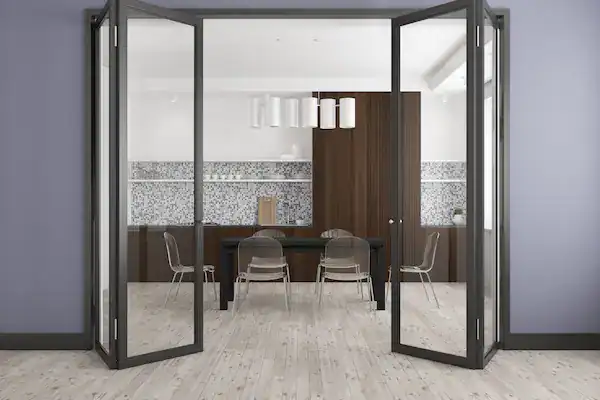Modern dining room with bifold glass doors and chairs.