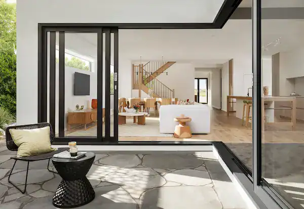 Modern open-concept living room with corner multi-slide large glass doors