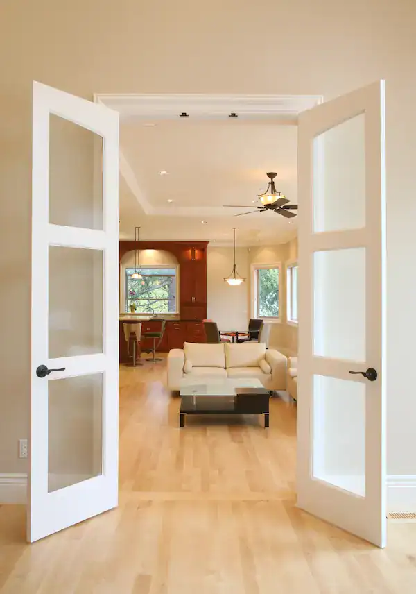 Open interior french doors to modern living room.