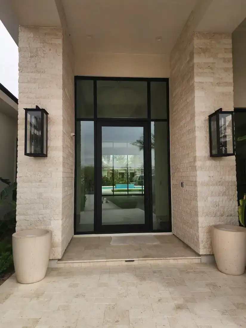 Modern glass entry door with black frame installed by A Pro Windows & Doors