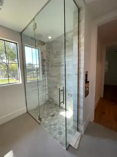 Modern frameless glass shower with tile accents installed by A Pro Windows & Doors