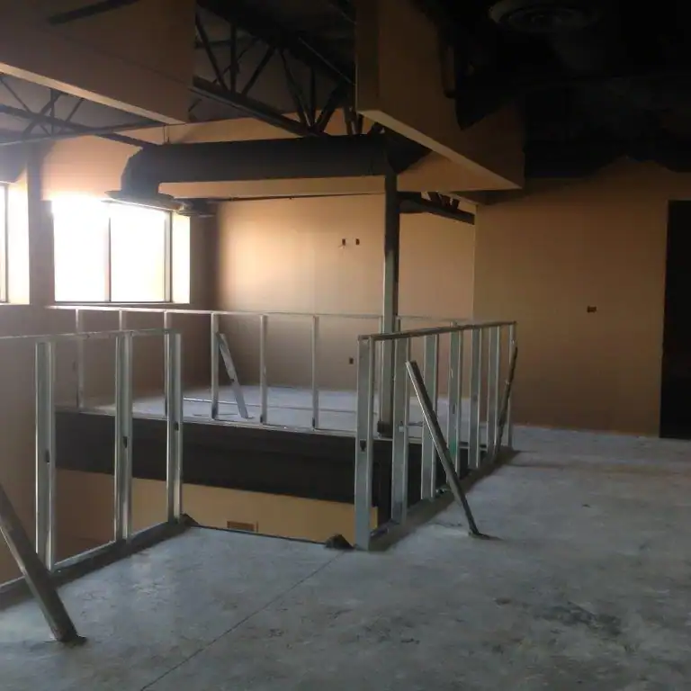 Unfinished interior construction of a second story with exposed metal framing from A Pro Windows & Door's past commercial project.