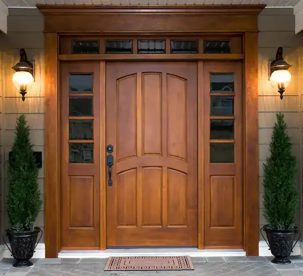Elegant wooden front door with sidelights and decor